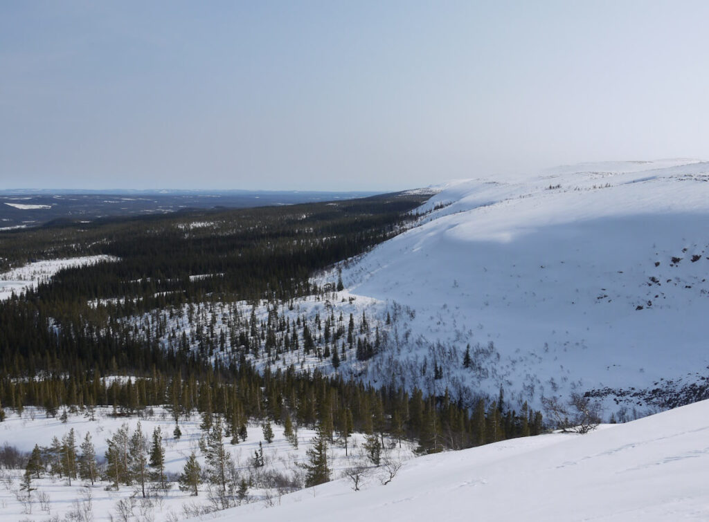 Blick vom Rand des Hochplateaus des Fulufjells nördlich des Wasserfalls Njupeskär über das Tal des den Njupeskär entwässernden Baches Stora Njupan hinweg an der Fjellkante entlang nach Südosten am 27.03.2014