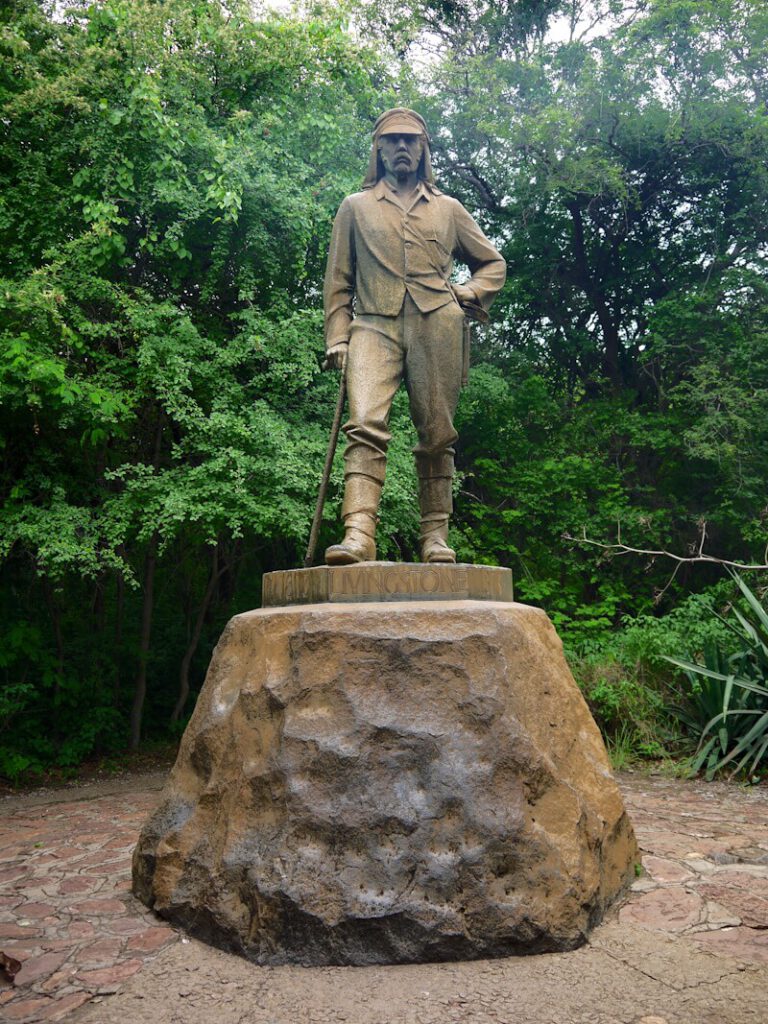 Monument to the African explorer David Livingstone (1813–1873) in front of Victoria Falls on the Zambezi River on November 29, 2025.
